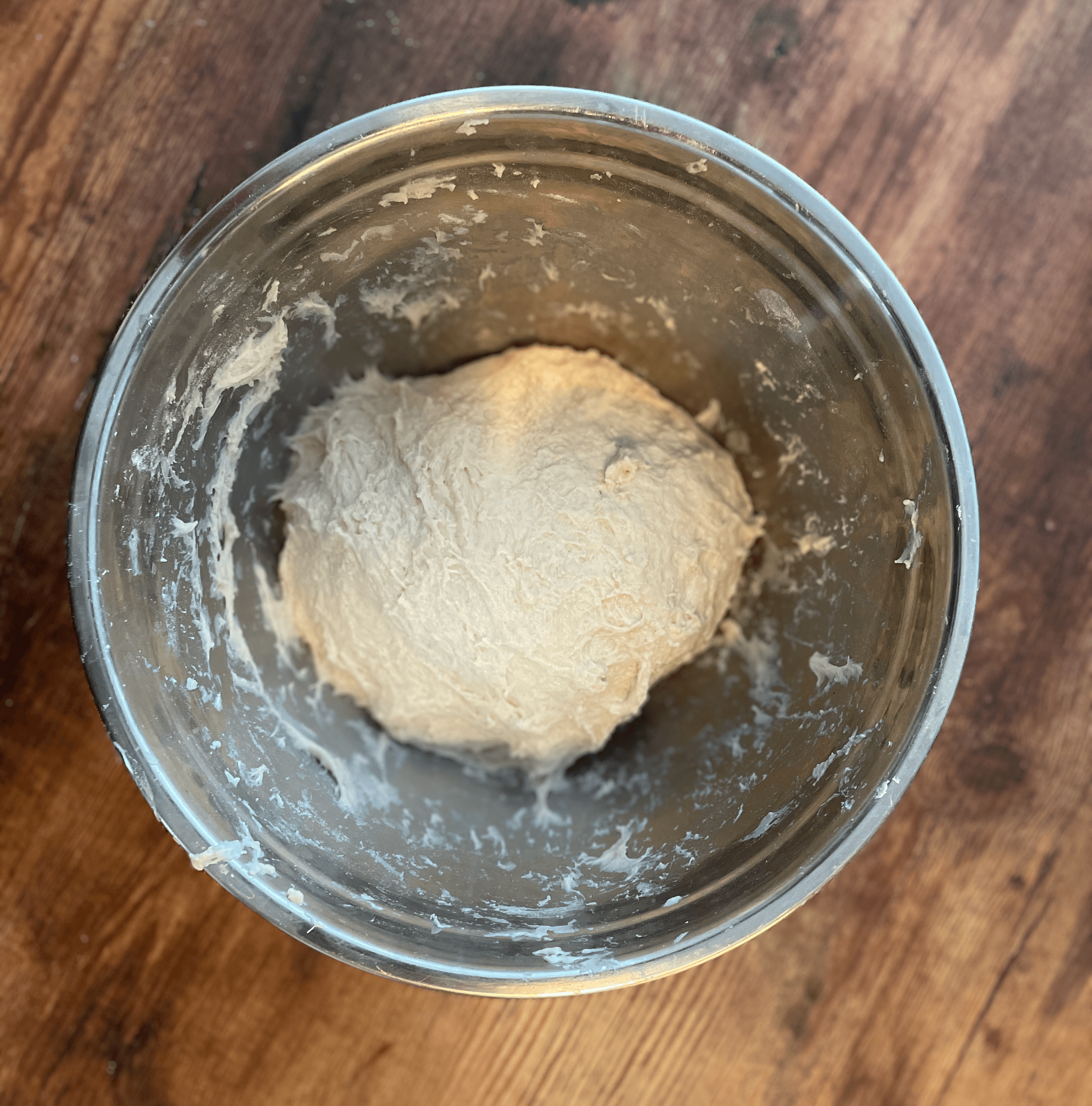 The salt should cause the dough to tighten so that it starts to smooth out a little bit.