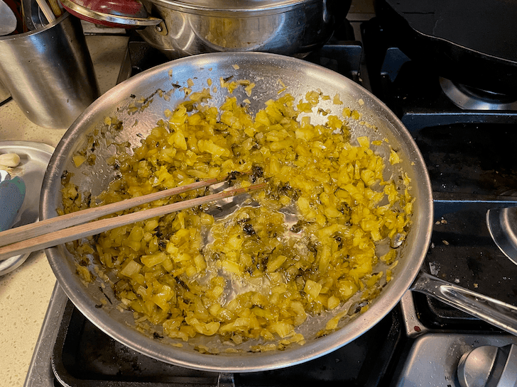 The mustard greens are done when the sugar has thickened into a syrup, with most water content evaporated.